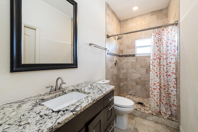 bathroom with vanity, toilet, and walk in shower