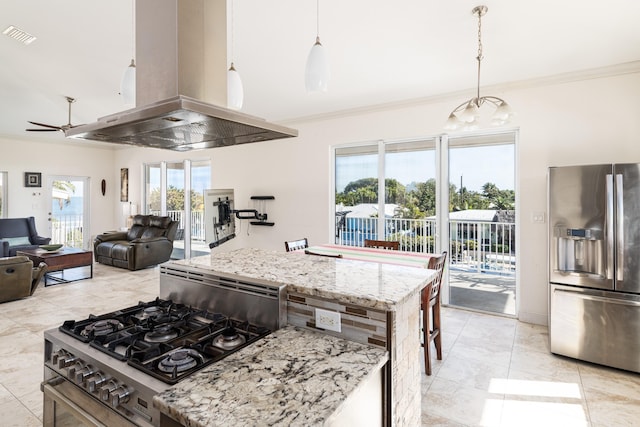 kitchen featuring light stone counters, island exhaust hood, stainless steel appliances, and hanging light fixtures