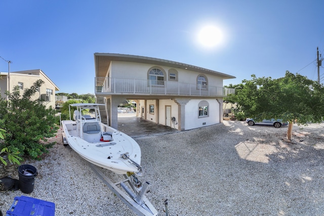 view of front of property featuring a carport and a balcony