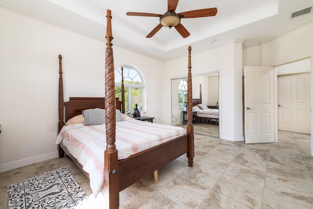 bedroom featuring a raised ceiling, ornamental molding, and ceiling fan