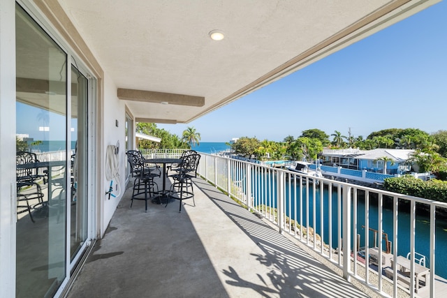 balcony featuring a water view