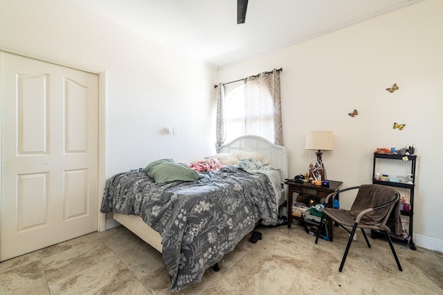 bedroom featuring ceiling fan and ornamental molding