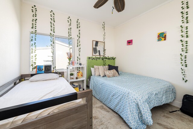 bedroom with ceiling fan and ornamental molding