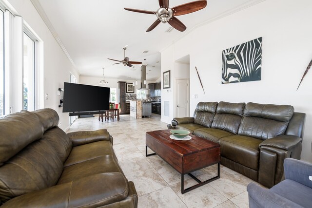 living room with crown molding and ceiling fan