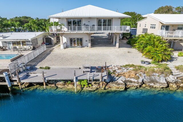 rear view of property with a water view