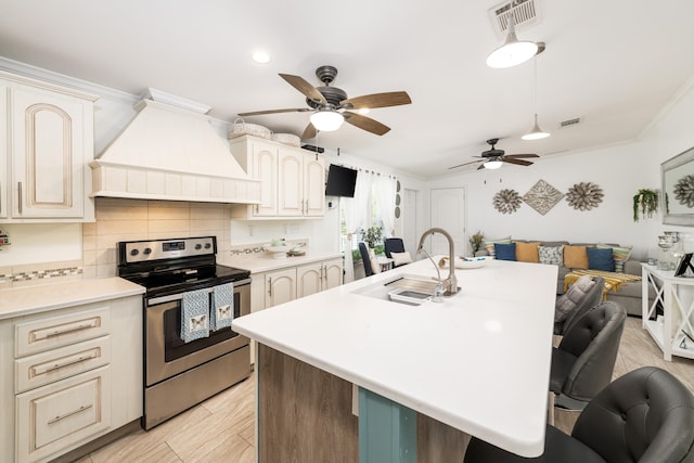 7 125th St, Gulf, Marathon, FL 33050 - kitchen with electric stove, premium range hood, a sink, a kitchen breakfast bar, and a ceiling fan