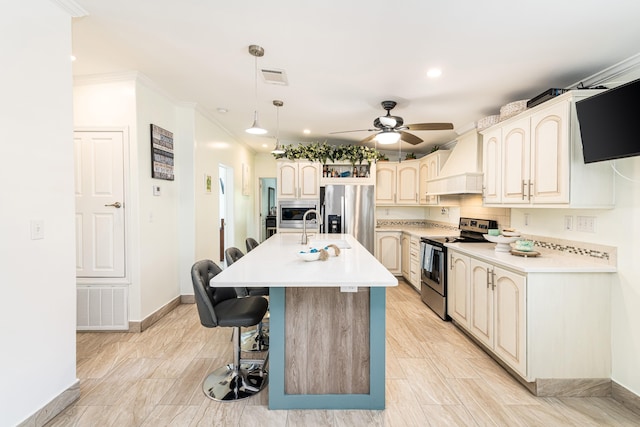 7 125th St, Gulf, Marathon, FL 33050 - kitchen with stainless steel appliances, premium range hood, a kitchen bar, baseboards, and a ceiling fan