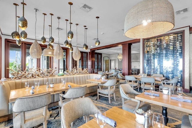 dining space featuring visible vents and a notable chandelier