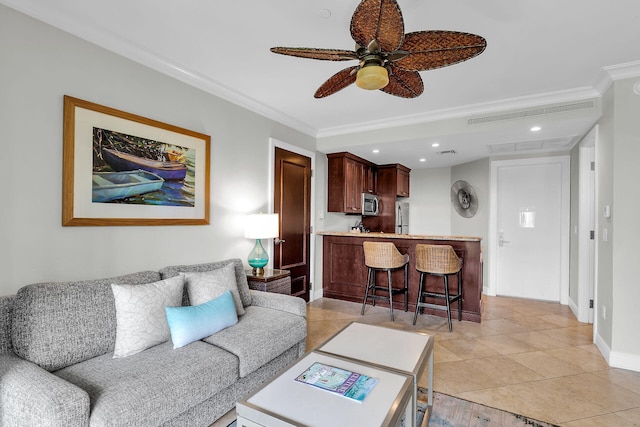 living area with light tile patterned floors, visible vents, ceiling fan, crown molding, and recessed lighting