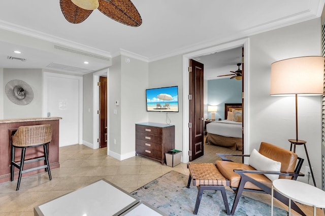 sitting room with ceiling fan, light tile patterned floors, visible vents, and crown molding