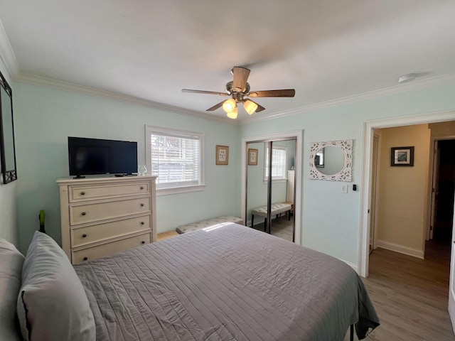 bedroom with ornamental molding, light wood-type flooring, and baseboards