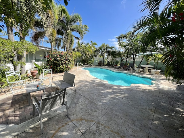 view of pool featuring fence, a fenced in pool, and a patio