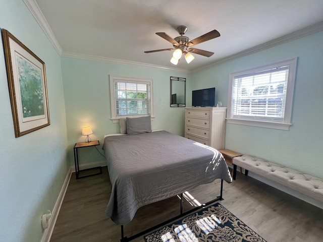 bedroom featuring ornamental molding, wood finished floors, a ceiling fan, and baseboards