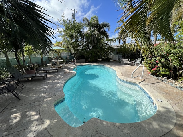 view of pool featuring a patio area, fence, and a fenced in pool