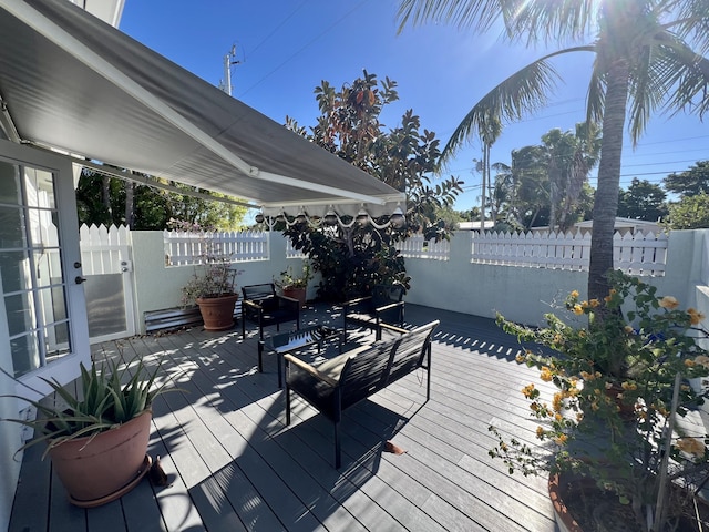 wooden terrace featuring fence