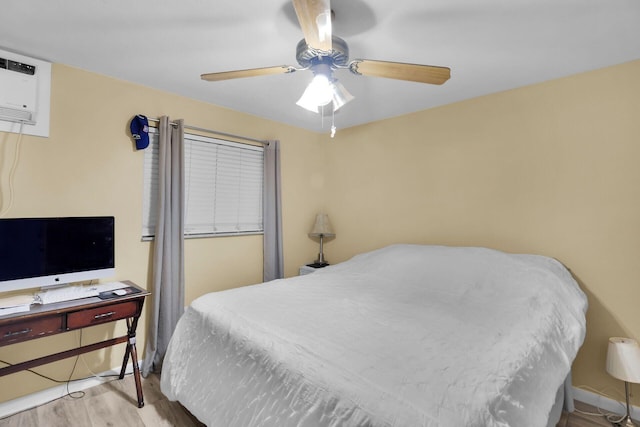 119 Cortez Dr Unit 8G, Islamorada, FL 33036 - bedroom featuring wood finished floors, a ceiling fan, and a wall mounted AC