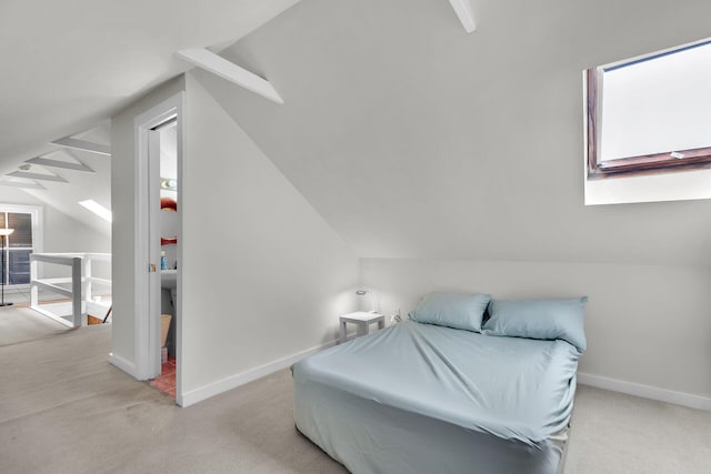 bedroom with lofted ceiling, baseboards, and carpet