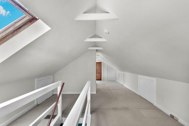 additional living space with lofted ceiling, baseboards, and carpet flooring
