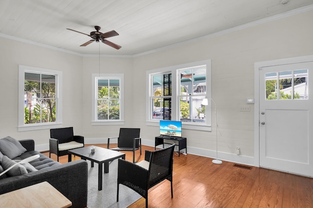 living room featuring a wealth of natural light, a ceiling fan, wood finished floors, and visible vents