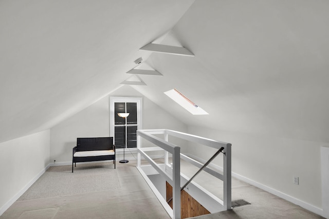 bonus room with lofted ceiling with skylight and baseboards