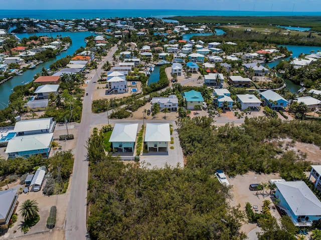 drone / aerial view with a water view and a residential view