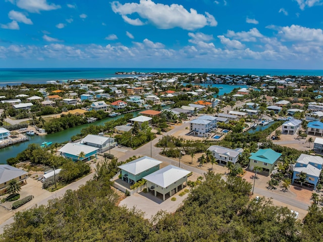 birds eye view of property featuring a water view and a residential view