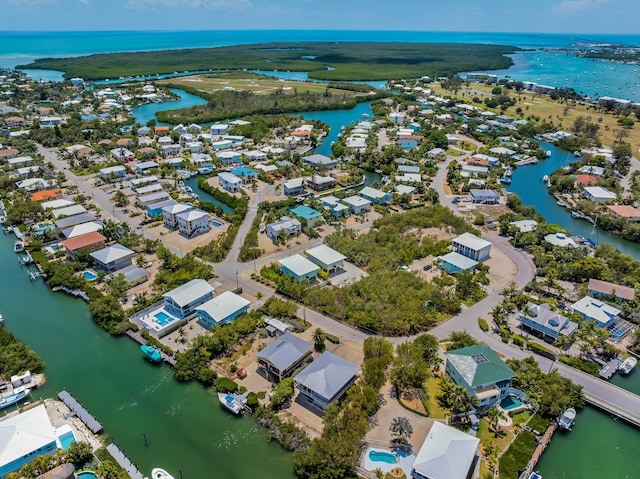 drone / aerial view with a water view and a residential view