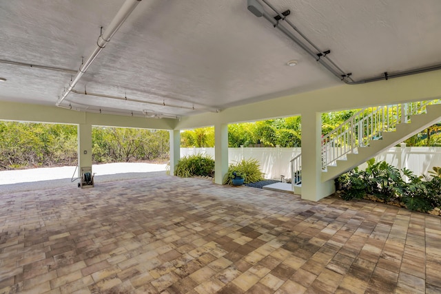 view of patio / terrace featuring stairs and fence
