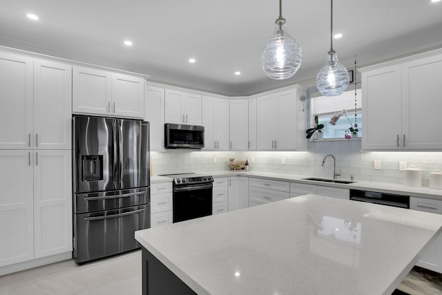 kitchen with backsplash, stainless steel appliances, white cabinets, and a sink
