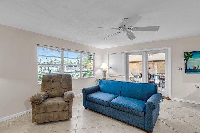 460470 11th St, Key Colony, FL 33051 - living area with light tile patterned floors, french doors, a ceiling fan, and baseboards