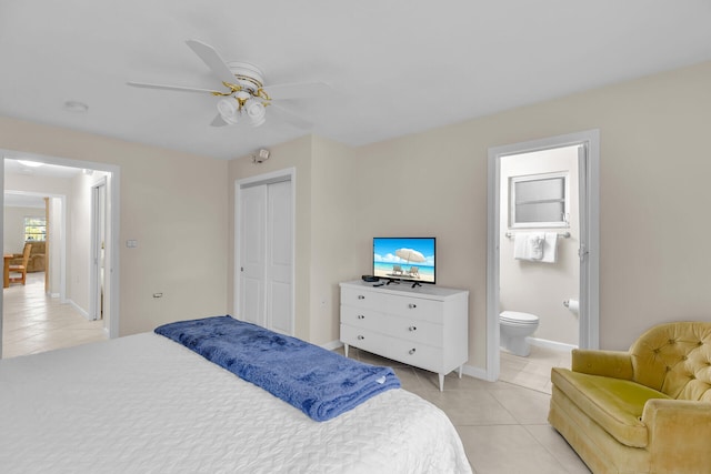 460470 11th St, Key Colony, FL 33051 - bedroom featuring light tile patterned floors, baseboards, ceiling fan, ensuite bathroom, and a closet