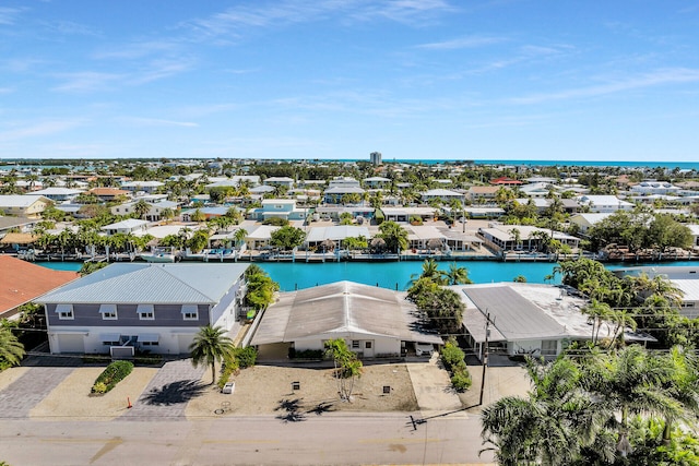 birds eye view of property with a water view and a residential view