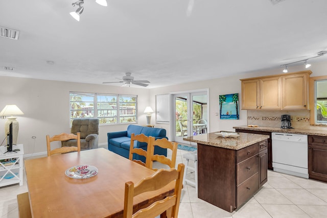 460470 11th St, Key Colony, FL 33051 - kitchen featuring light tile patterned floors, visible vents, decorative backsplash, dishwasher, and a center island