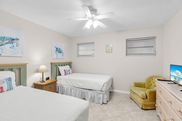 460470 11th St, Key Colony, FL 33051 - bedroom with light tile patterned floors, a ceiling fan, and baseboards