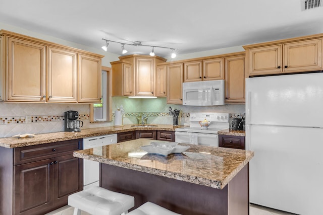 460470 11th St, Key Colony, FL 33051 - kitchen featuring white appliances, visible vents, decorative backsplash, a kitchen island, and a breakfast bar