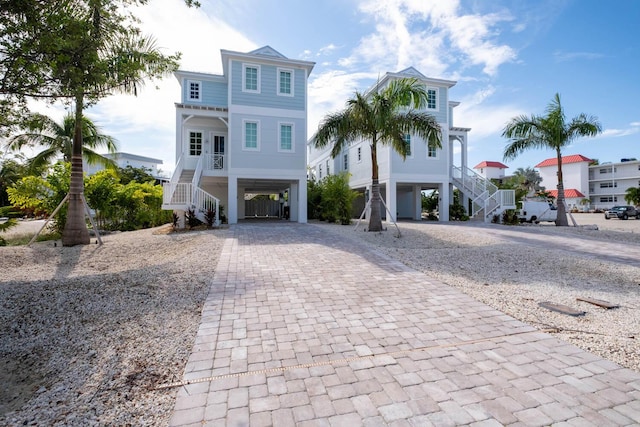 raised beach house featuring a carport