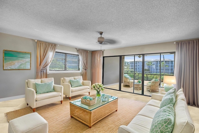 living room featuring a textured ceiling and baseboards