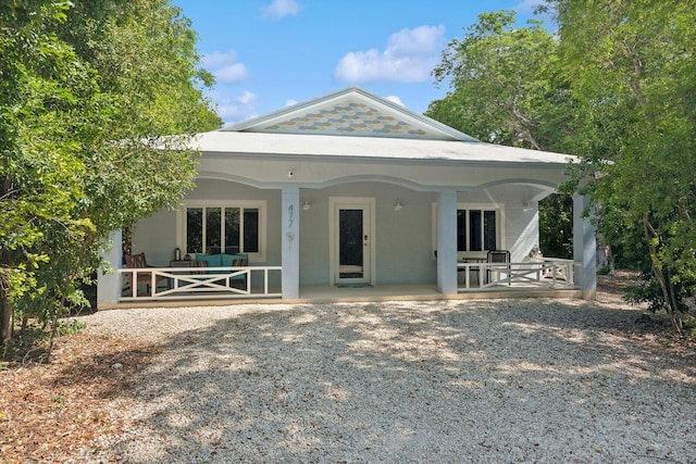 back of property with a porch