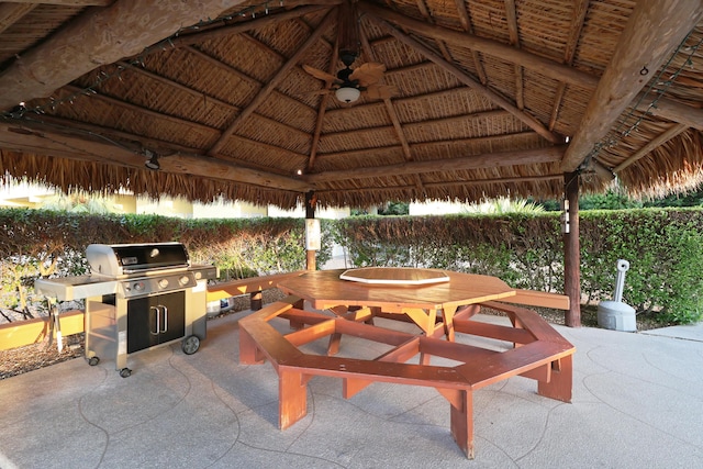 view of patio / terrace with a gazebo, outdoor dining area, a grill, and a ceiling fan