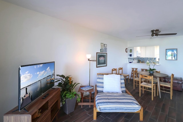 living area with ceiling fan and wood tiled floor