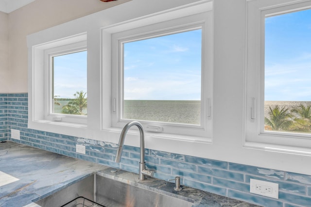 room details featuring sink and decorative backsplash