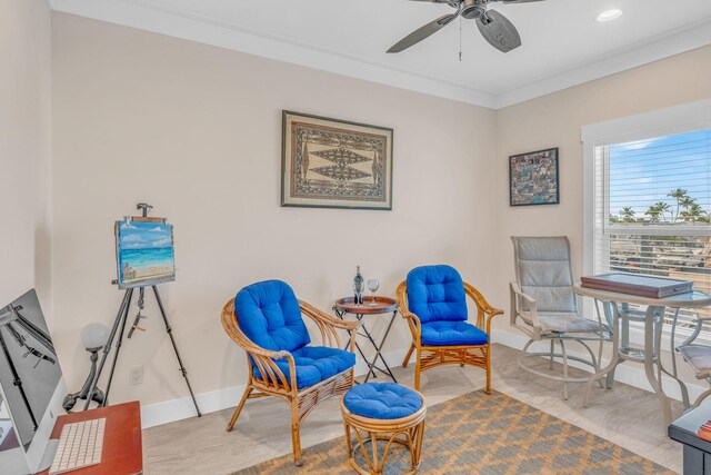 sitting room featuring ornamental molding and ceiling fan