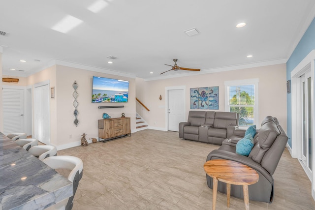 living room with ornamental molding and ceiling fan