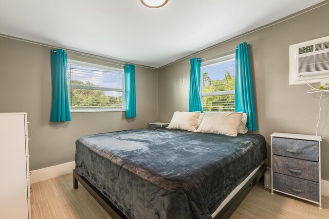 bedroom featuring a wall unit AC