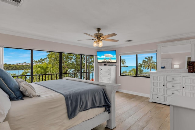 bedroom featuring a water view, ceiling fan, ornamental molding, and light hardwood / wood-style flooring