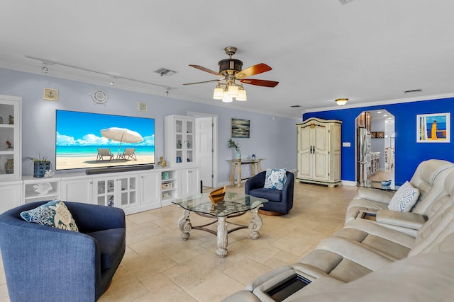 living room with crown molding, rail lighting, and ceiling fan