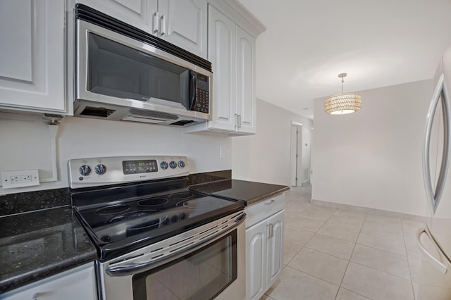 kitchen featuring appliances with stainless steel finishes, light tile patterned floors, pendant lighting, and white cabinetry