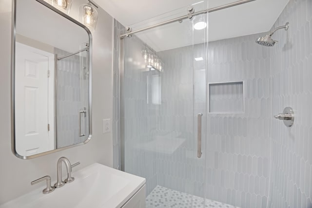 bathroom featuring vanity and a shower stall