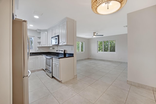 kitchen with light tile patterned floors, ceiling fan, open shelves, dark countertops, and stainless steel appliances