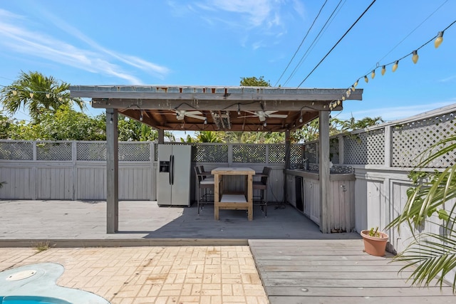 deck featuring ceiling fan, a gazebo, and a fenced backyard